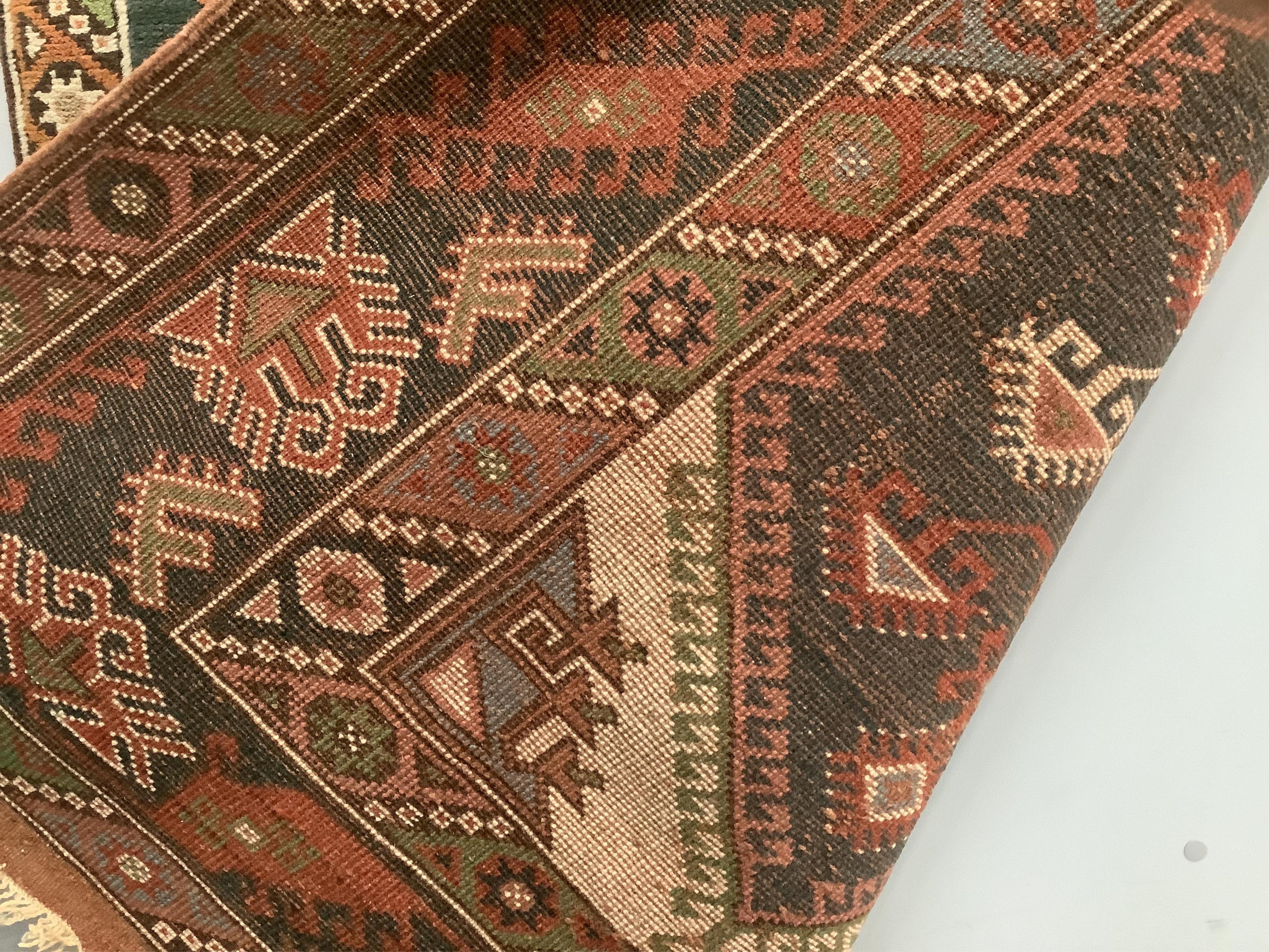 A Caucasian style multicoloured geometric rug, 190 x 130cm. Condition - fair